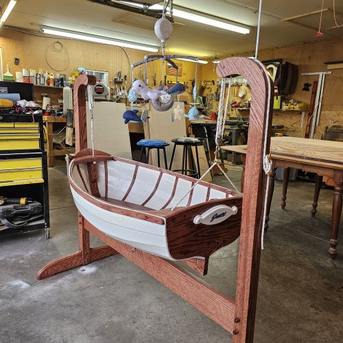 a picture of a commissioned baby bassinet in the shape of a boat