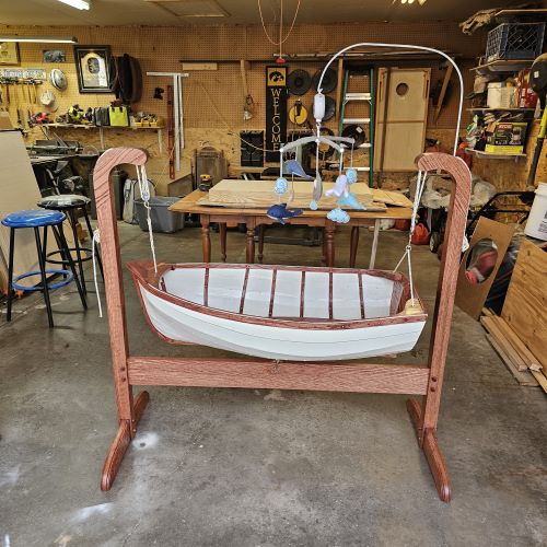 a picture of a commissioned baby bassinet in the shape of a boat