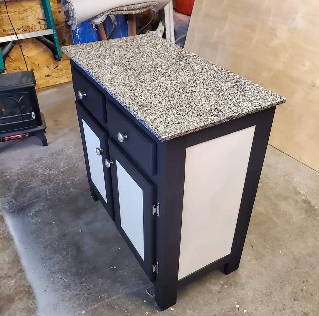 a picture of a granite topped rolling cabinet or counter top